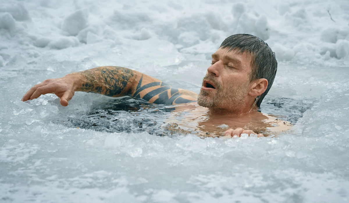 Man swimming in frozen water